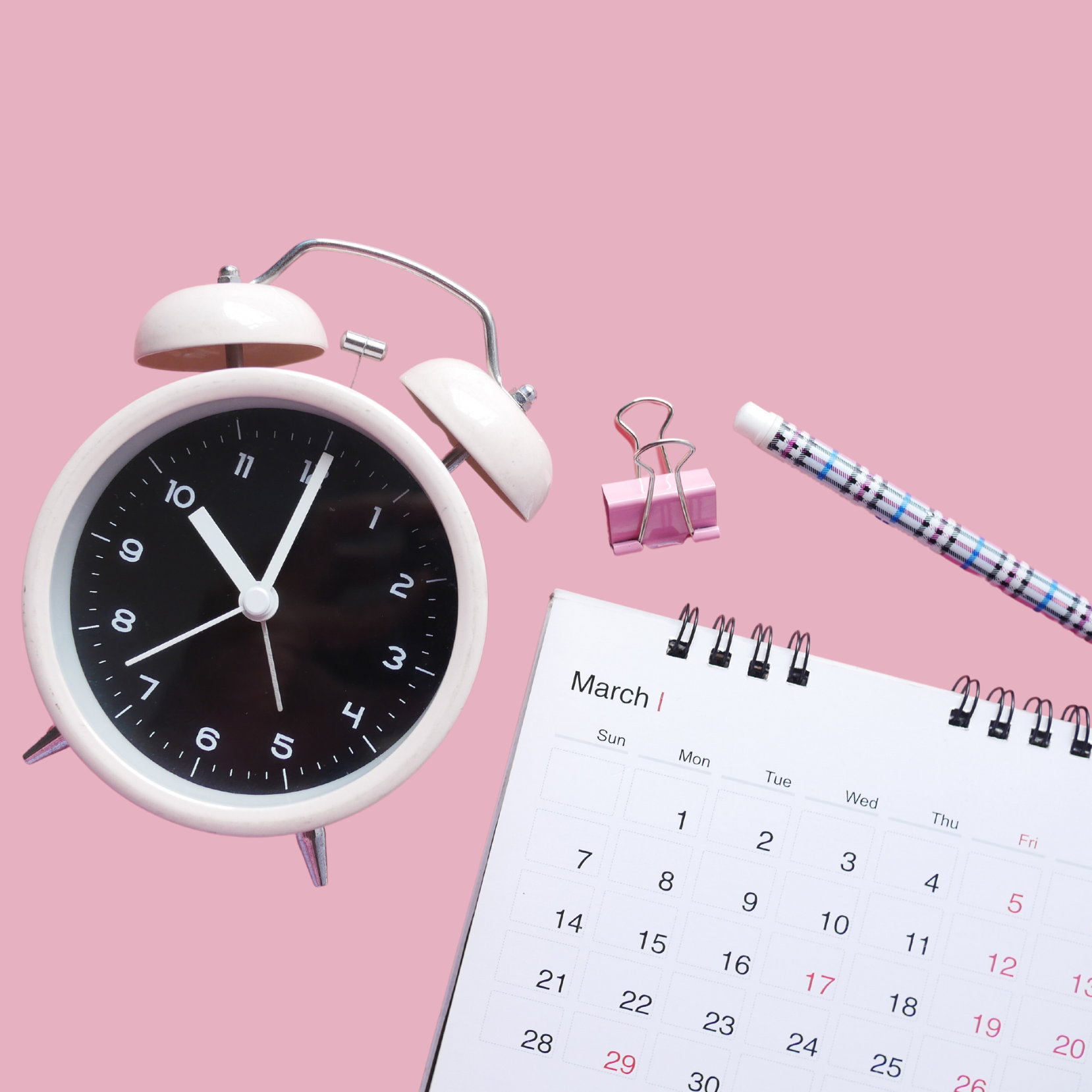 Alarm clock, calendar and pen.