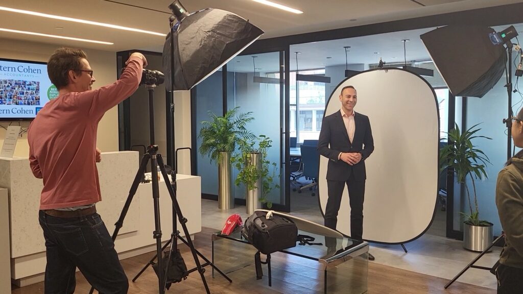 Photograph of a photo shoot at Stern Cohen with the photographer and Partner Avi Gleeck.