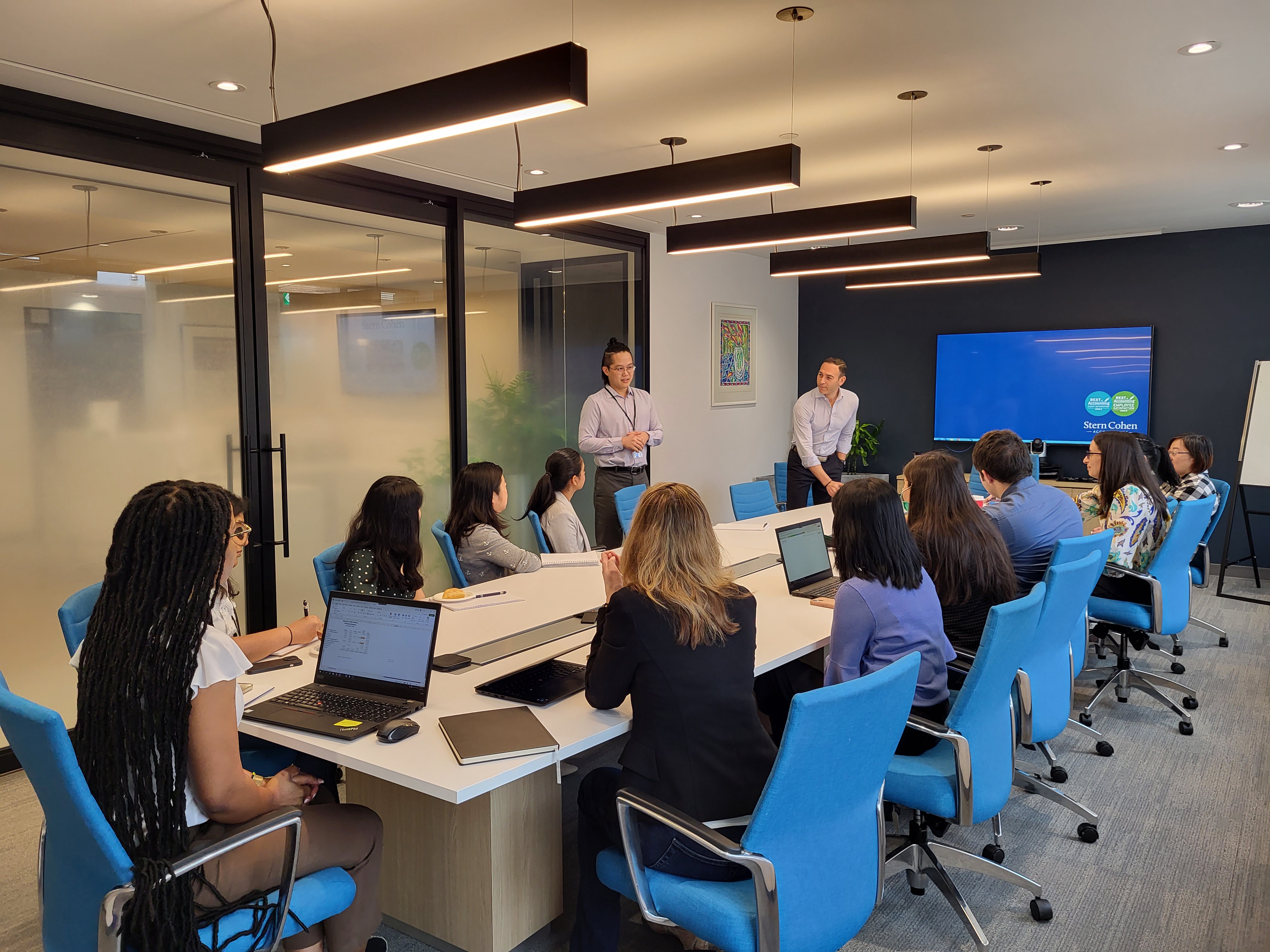 Group of Stern Cohen accountants at a Tax Season workshop sitting in a boardroom.