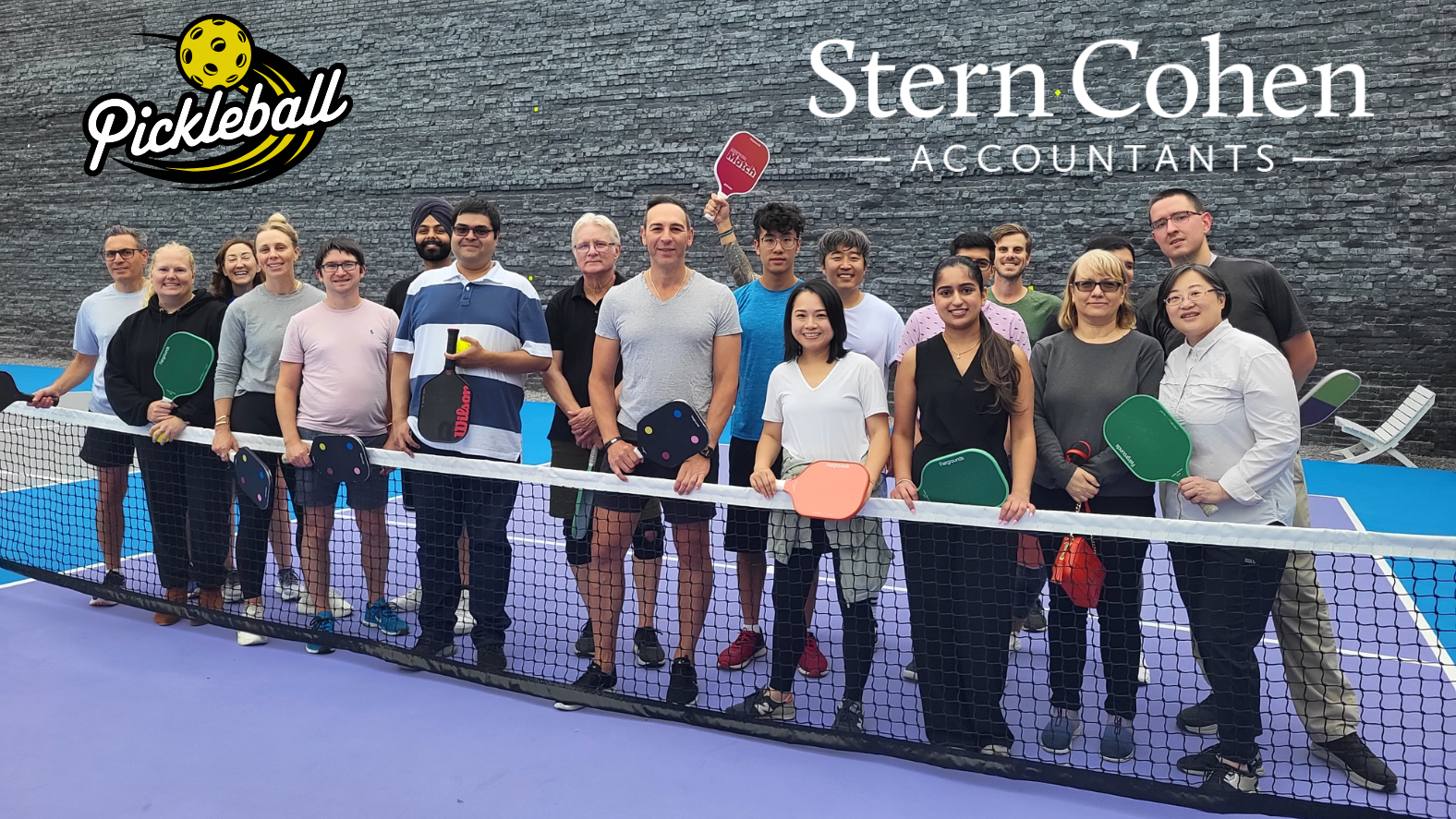 Group of Stern Cohen Accountants posing for a team photo on the pickleball court.